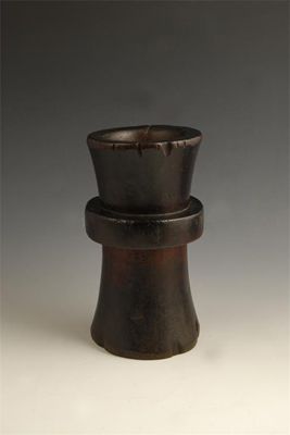 Appraisal: A wood mortar of waisted girdled form probably Indonesian in