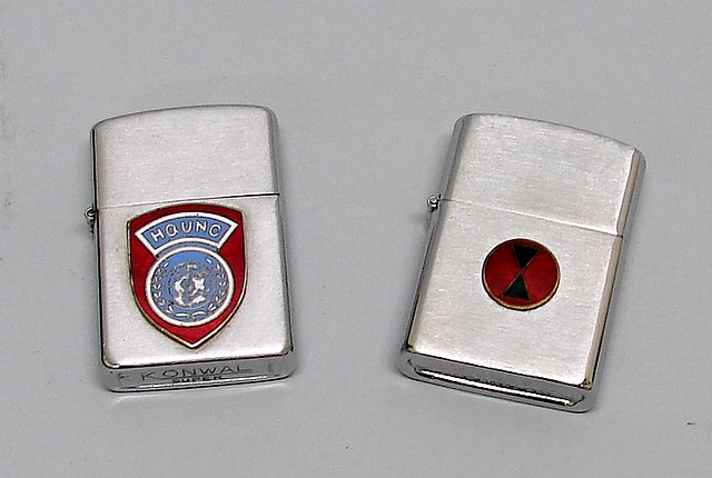 Appraisal: Pair of lighters including Konwal lighter featuring enameled Headquarters United