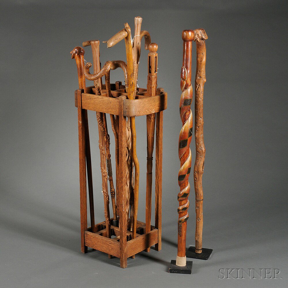 Appraisal: Twelve Carved Canes and a Mission Oak Cane Stand mostly