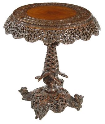 Appraisal: A Burmese hardwood tilt-top occasional table profusely carved with birds