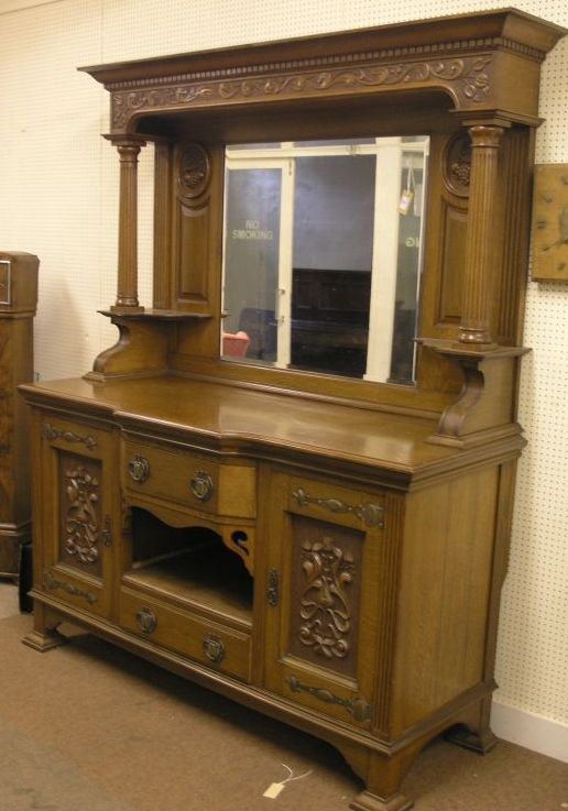 Appraisal: An Art Nouveau solid oak sideboard raised back carved with