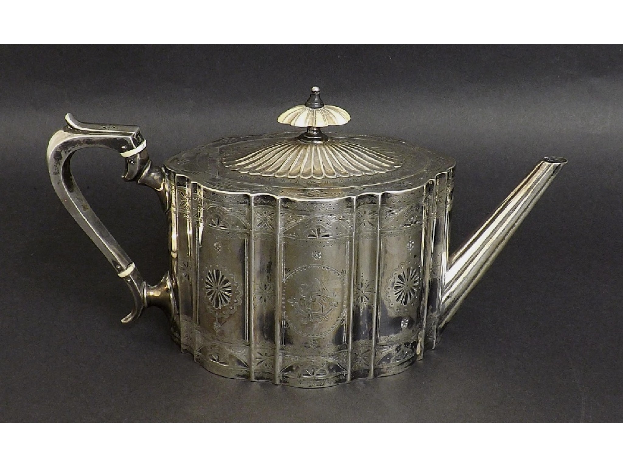 Appraisal: Victorian silver teapot of oval serpentine form engraved with floral