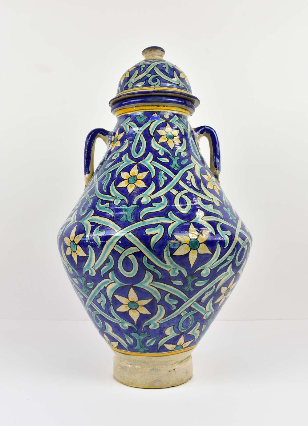 Appraisal: MOROCCAN CERAMIC TWO-HANDLED COVERED JAR th Century Decorated allover in