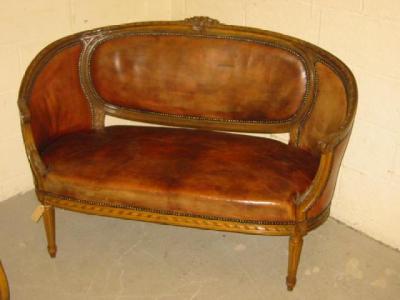 Appraisal: A FRENCH OAK FRAMED CANAPE of curved outline upholstered in