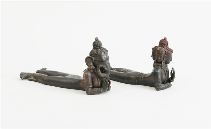 Appraisal: PAIR OF INDIAN BRONZE RECLINING FIGURES REPRESENTING GANESH AND BRAHMA