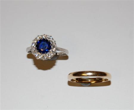 Appraisal: A sapphire and diamond cluster platinum mounted ring the central