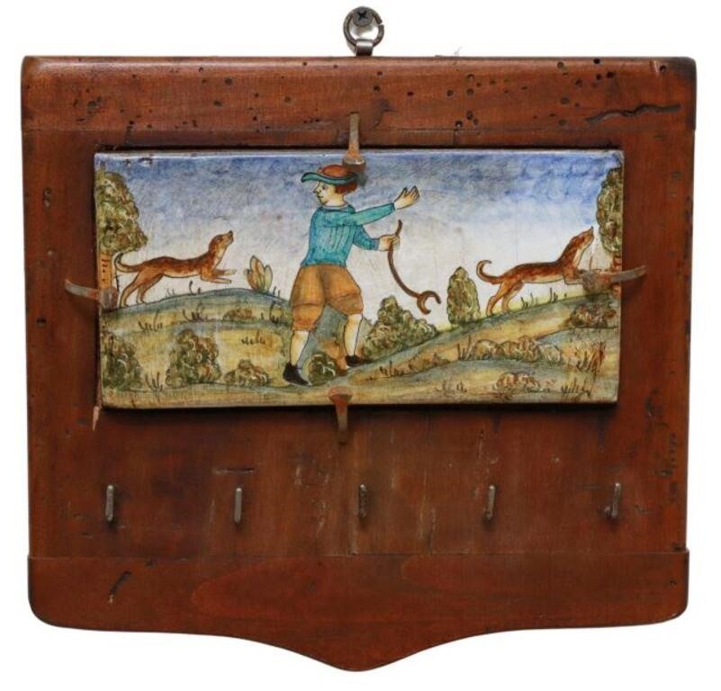 Appraisal: French faience wall-mounted key rack painted ceramic tile with figural