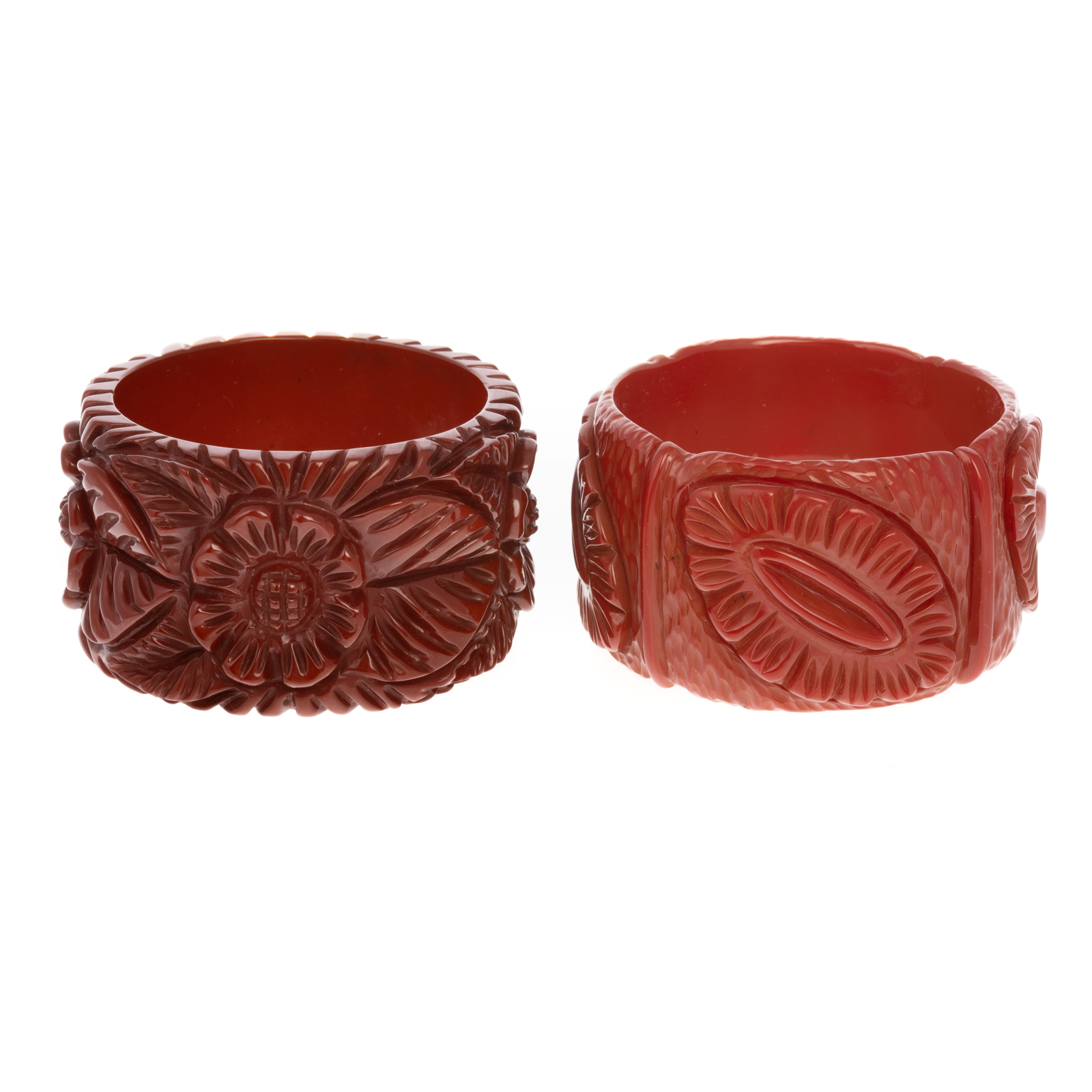 Appraisal: A PAIR OF DEEPLY CARVED BAKELITE BANGLES Floral patterns round