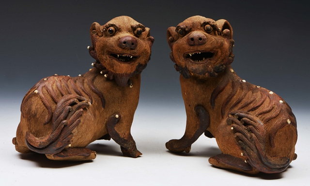 Appraisal: A PAIR OF OLD ORIENTAL POTTERY SEATED KYLINS with mottle