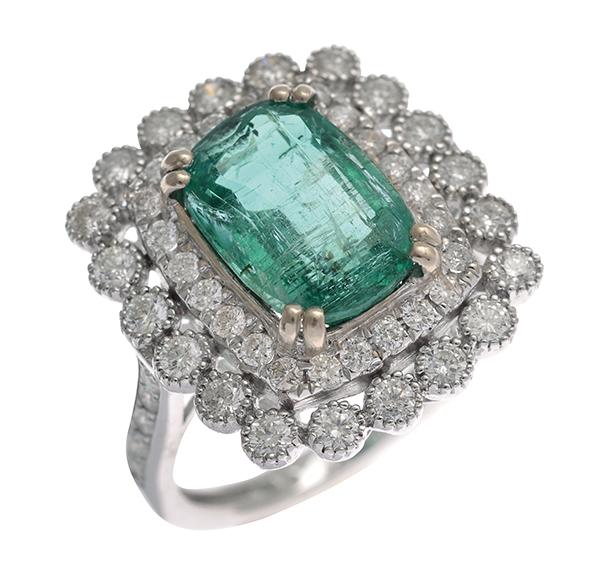 Appraisal: AN EMERALD AND DIAMOND CLUSTER RING Centrally set with a