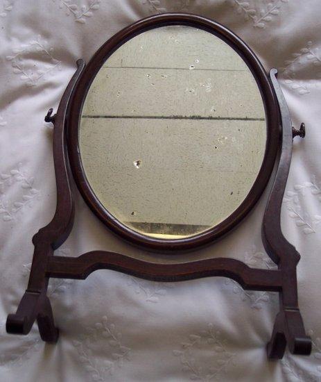 Appraisal: A George III style oval swing frame mirror cm high