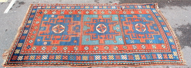 Appraisal: AN OLD KASAK RUST GROUND RUG decorated a central triple