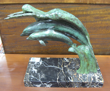 Appraisal: BRONZE FIGURAL GROUP mermaid with outstretched arms over two dolphin