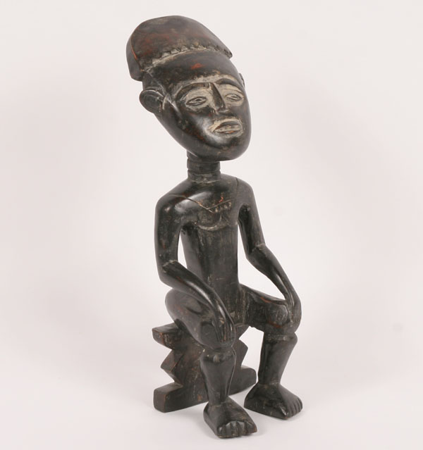 Appraisal: Ashanti carved wood seated figure figure in ceremonial head gear