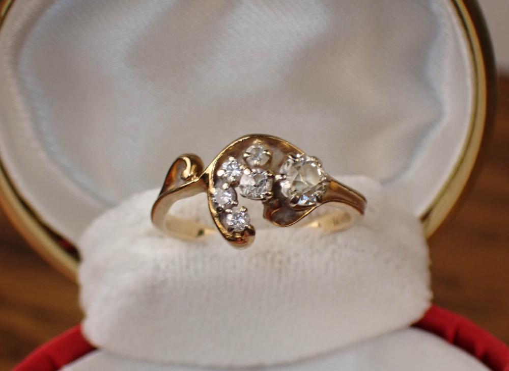 Appraisal: DIAMOND AND FOURTEEN KARAT GOLD RING set with six round-cut