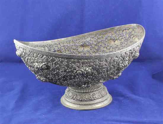 Appraisal: An Indian pierced white metal boat shaped fruit bowl decorated