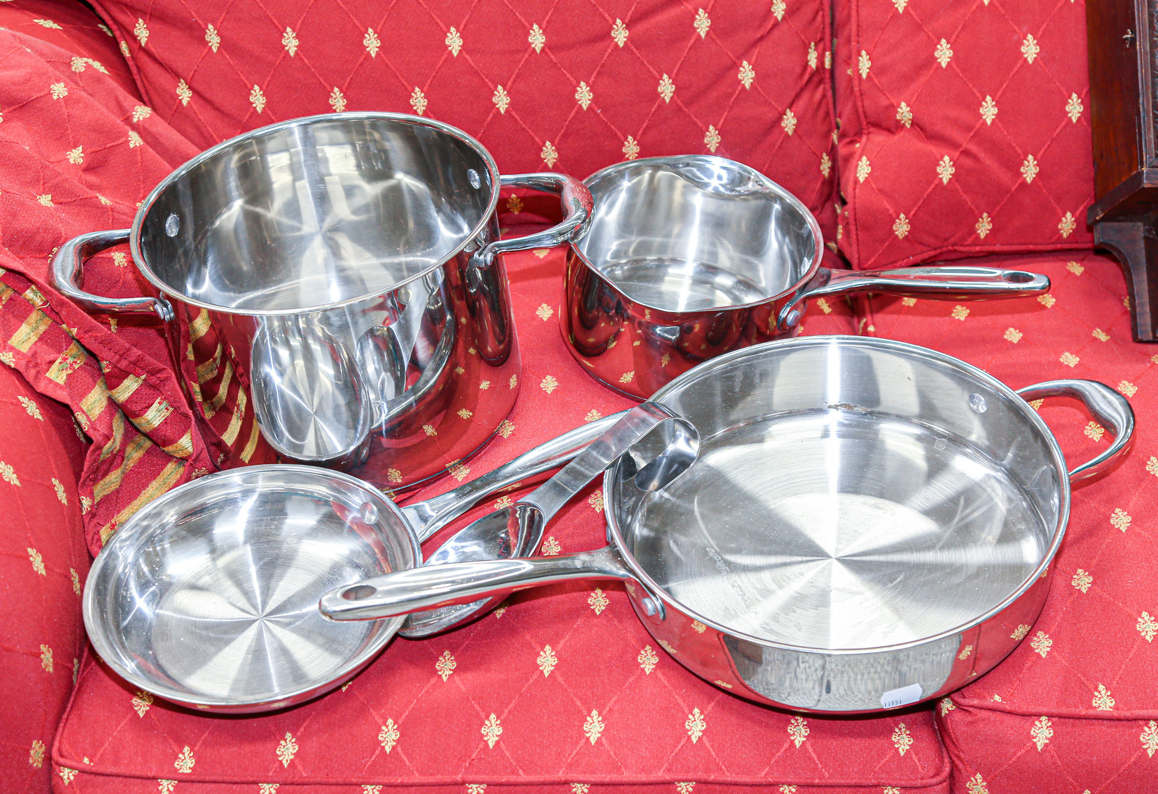 Appraisal: SELECTION OF WOLFGANG PUCK COOKWARE Comprising four stainless steel pots