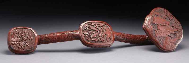 Appraisal: Chinese Qing carved cinnabar ruyi scepterdepicting immortals lucky symbols and