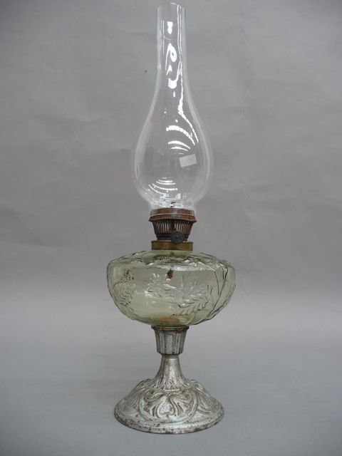 Appraisal: An oil lamp with flower embossed glass body in pale