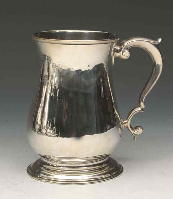 Appraisal: A GEORGE III BALUSTER SHAPED SILVER TANKARD on turned stepped