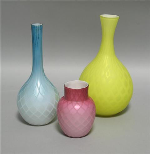 Appraisal: THREE QUILTED SATIN GLASS VASES Including one yellow bottle shaped