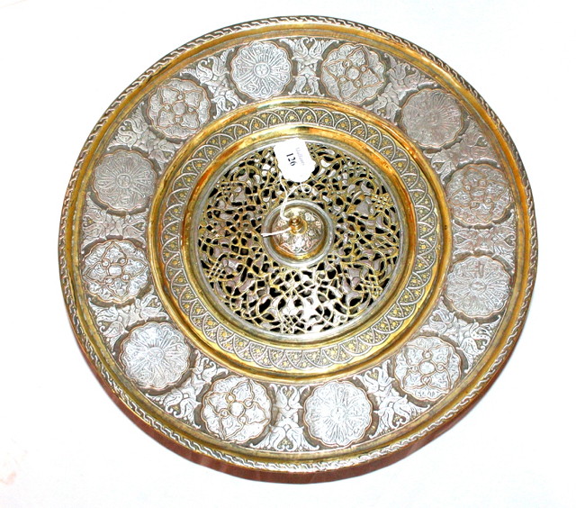 Appraisal: A MIDDLE EASTERN ISLAMIC AND SILVER COLOURED METAL CIRCULAR ROSEWATER