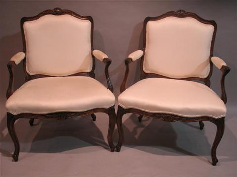 Appraisal: PAIR OF LOUIS XV STYLE FAUTEUILS Twentieth century carved crest