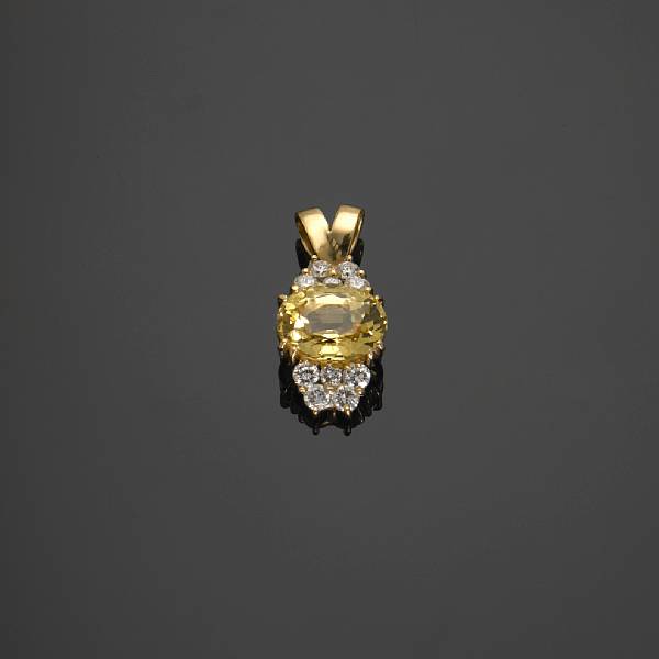 Appraisal: A natural yellow sapphire and diamond pendant sapphire weighing approximately