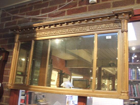 Appraisal: A LATE TH CENTURY REGENCY STYLE OVERMANTEL MIRROR with scallop