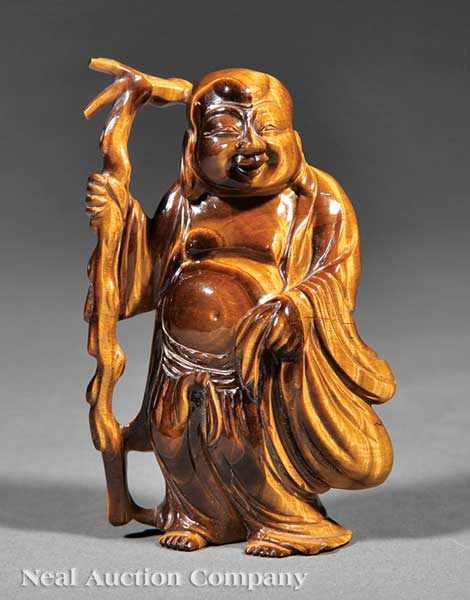 Appraisal: A Chinese Tiger's Eye Figure of Budai carved wearing voluminous