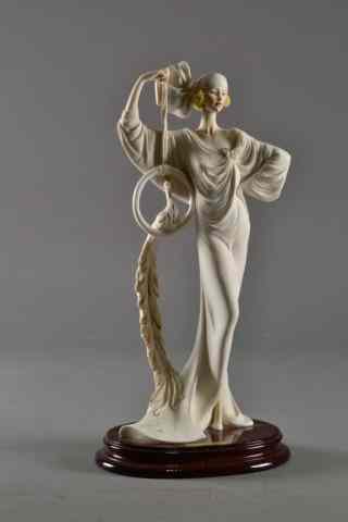 Appraisal: A SANTINI ART DECO FEMALE STATUE PEACOCKDepicting a contemporary statue