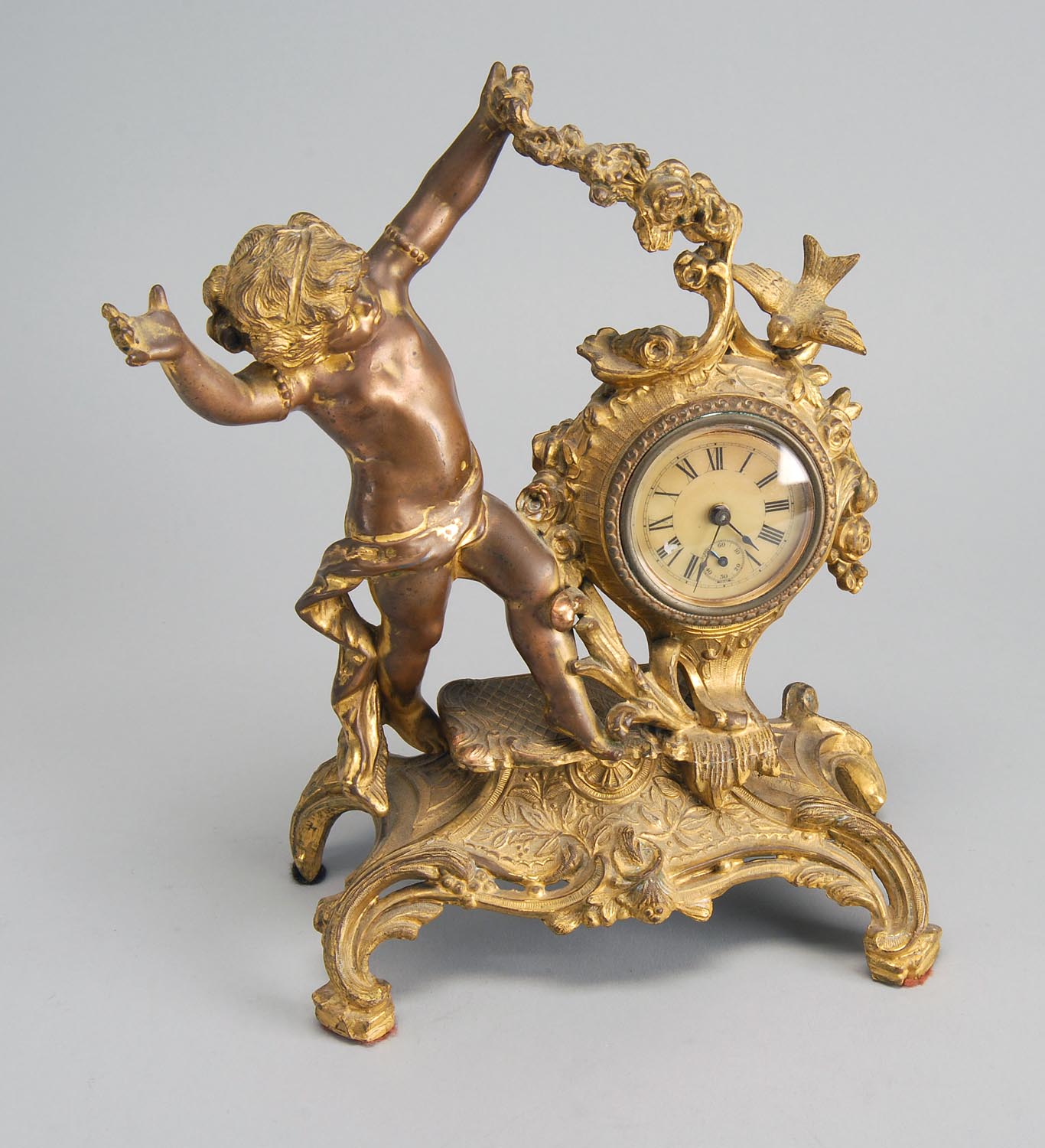 Appraisal: FIGURAL SHELF CLOCK Early th CenturyIn brass and metal Figure