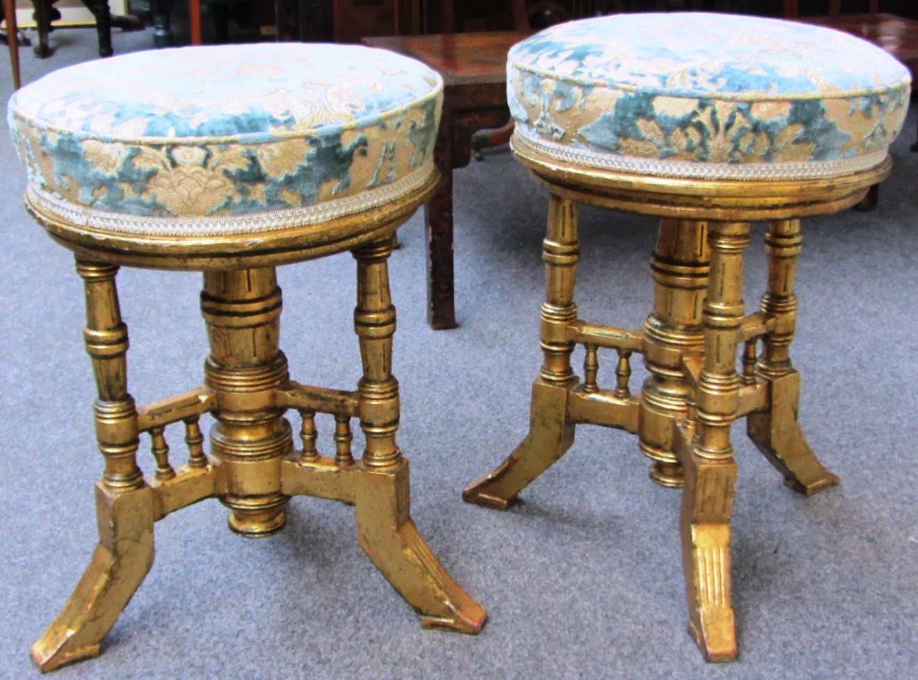 Appraisal: A pair of Arts and Crafts gilt wood piano stools