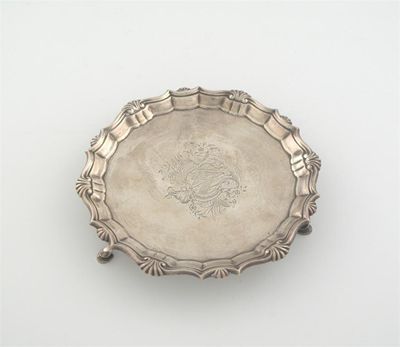 Appraisal: A George II waiter with a shell and scroll border