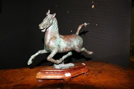 Appraisal: A Chinese bronze horse in Tang style on wooden stand