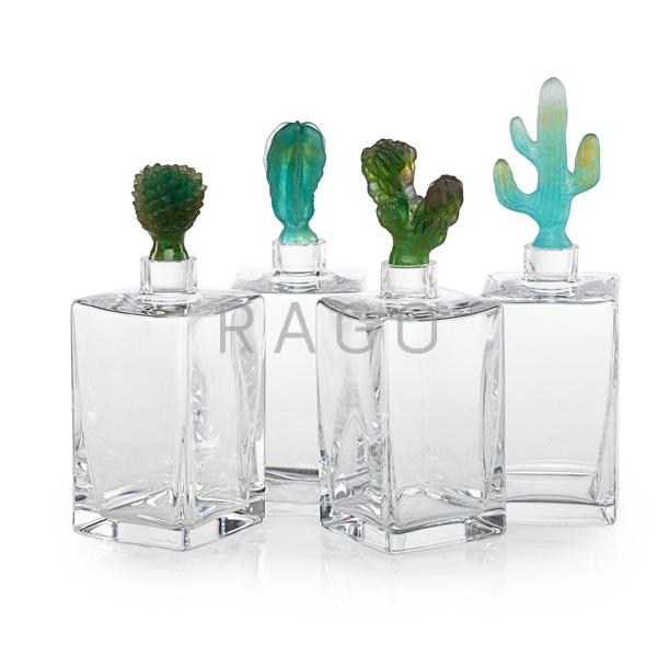 Appraisal: DAUM Four cactus decanters Condition Report Two stoppers with possible