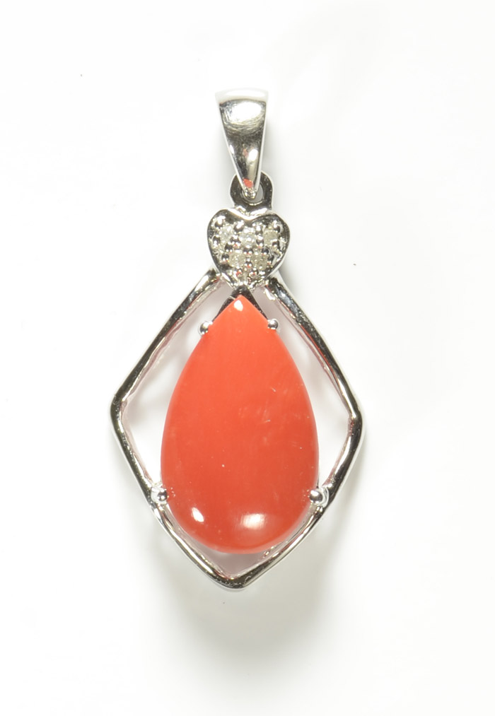 Appraisal: CORAL AND FOURTEEN KARAT WHITE GOLD PENDANT with five round-cut