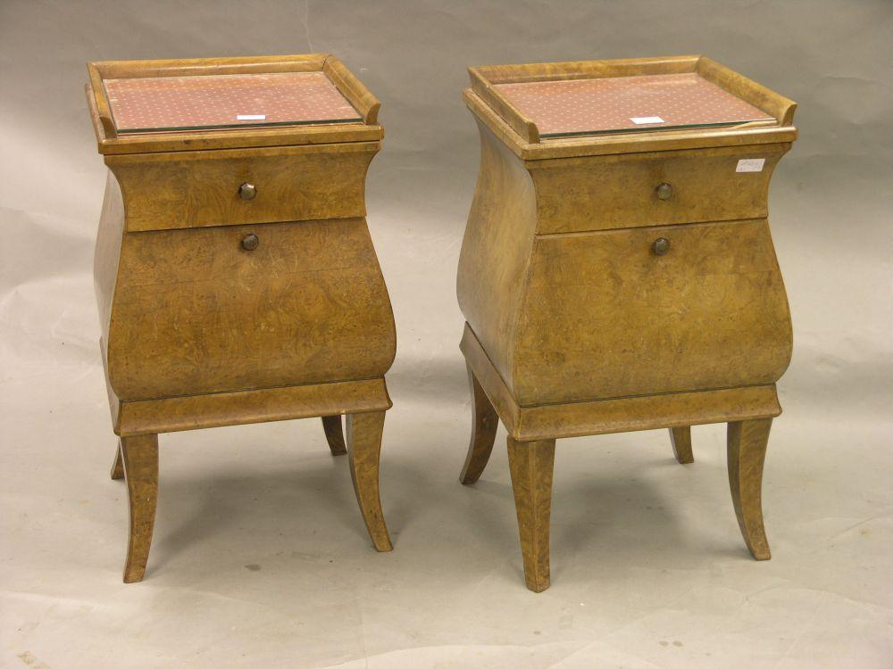 Appraisal: A pair of burr walnut bombe-shape bedside cupboards each with