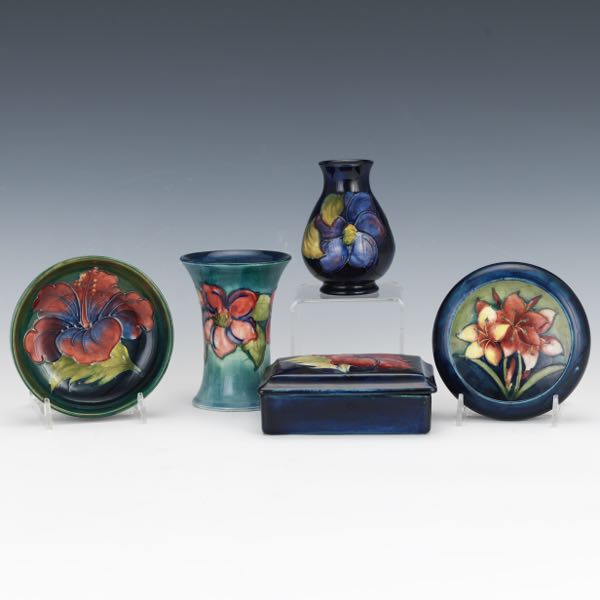 Appraisal: GROUP OF FIVE MOORCROFT CERAMIC PIECES Including a beaker vase