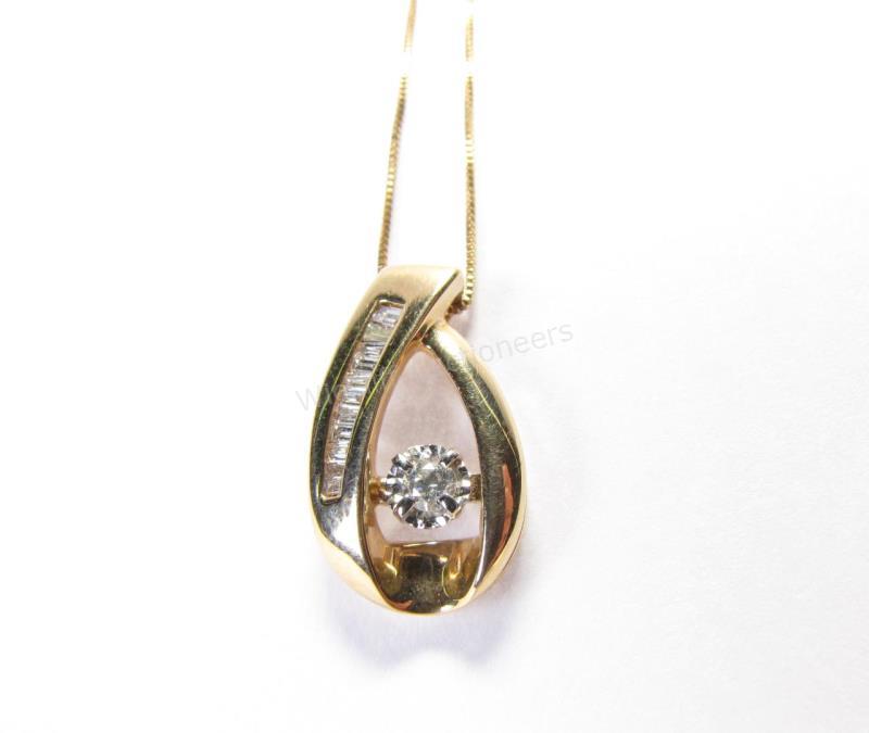 Appraisal: A K yellow gold pendant with round diamond center accented