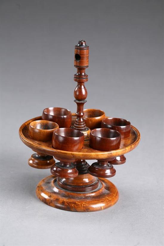 Appraisal: TREEN EGG CUP HOLDER American th century maple Bird's-eye maple