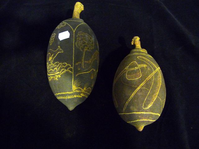 Appraisal: Two carved Boab nuts the larger signed Russell Bandy enriched