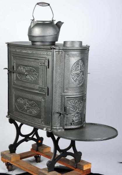 Appraisal: Pine Grove Cast Iron Stove with Tea Kettle Wonderful piece