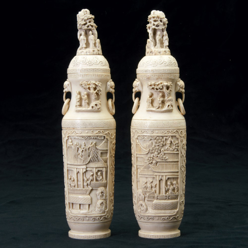 Appraisal: CHINESE IVORY Pair of covered vases carved with panels of