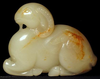 Appraisal: Chinese white jade ram carving The recumbent beast carved in