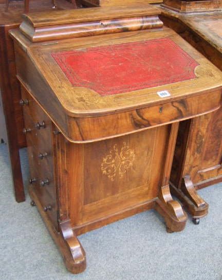 Appraisal: A Victorian walnut davenport the lift top with fitted interior