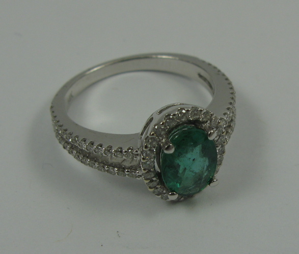 Appraisal: EMERALD DIAMOND AND K WHITE GOLD RING centering an oval-cut