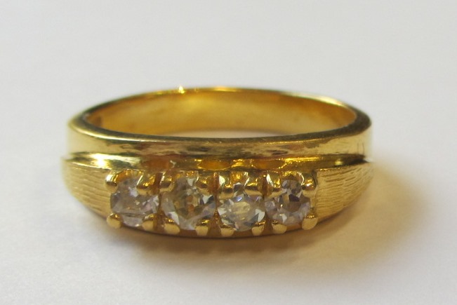 Appraisal: A gold and diamond set four stone ring mounted with