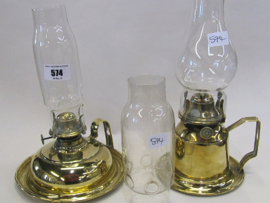 Appraisal: Two brass based paraffin lamps with spare glass funnel