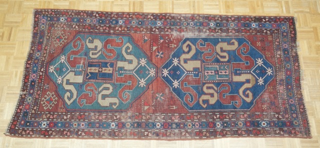 Appraisal: Antique Caucasian Rug Red field with two large blue medallions